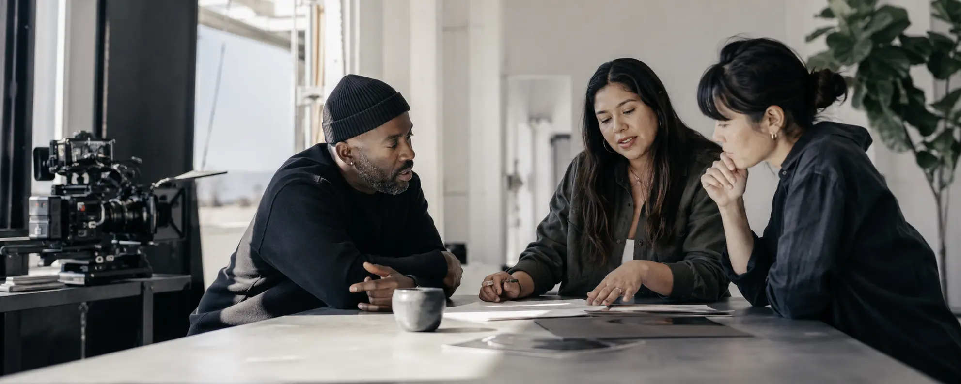 Three creative professionals focused on a discussion together